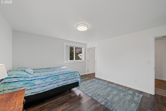 bedroom featuring baseboards and wood finished floors
