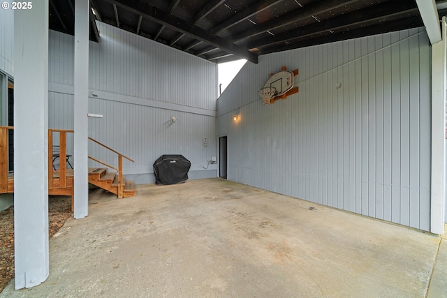unfurnished living room featuring a garage and concrete flooring