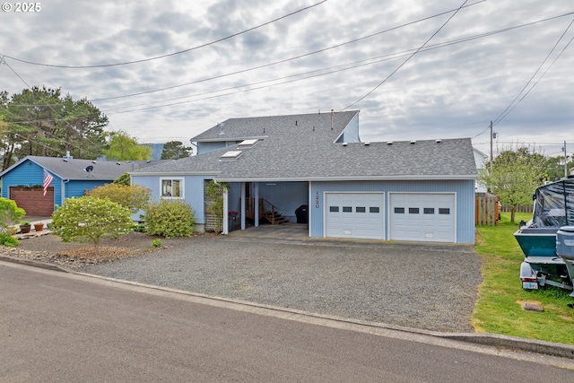 single story home with a garage, roof with shingles, and aphalt driveway