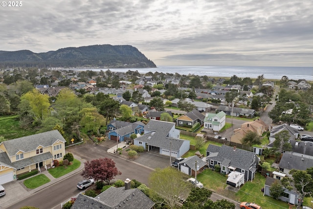 birds eye view of property with a water and mountain view and a residential view