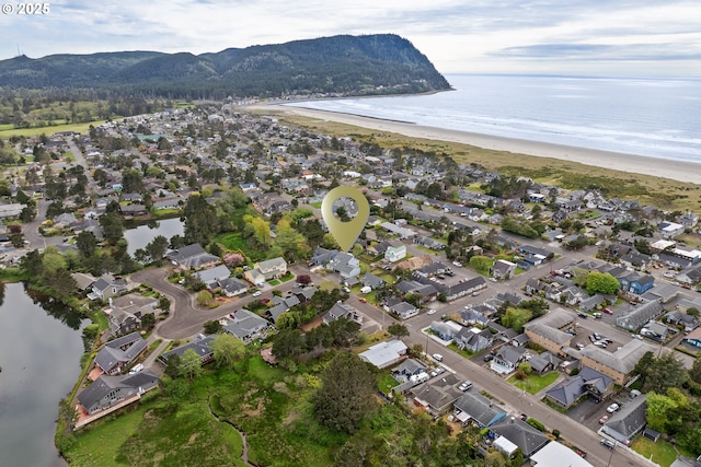 drone / aerial view with a residential view and a water and mountain view