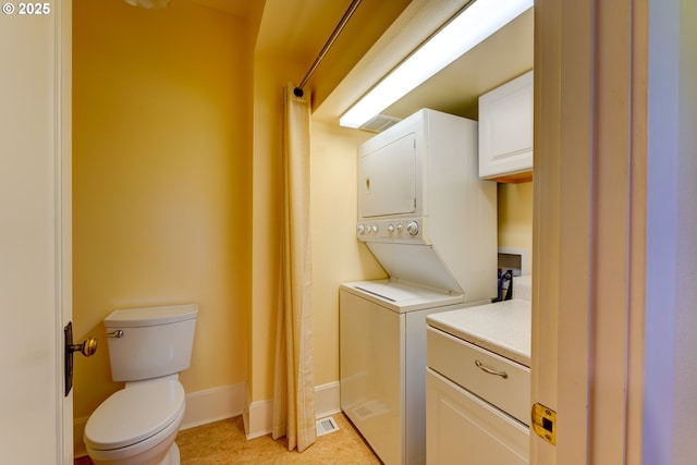 1203 SE 53rd Ave, Portland, OR 97215 - washroom featuring stacked washer and clothes dryer and baseboards