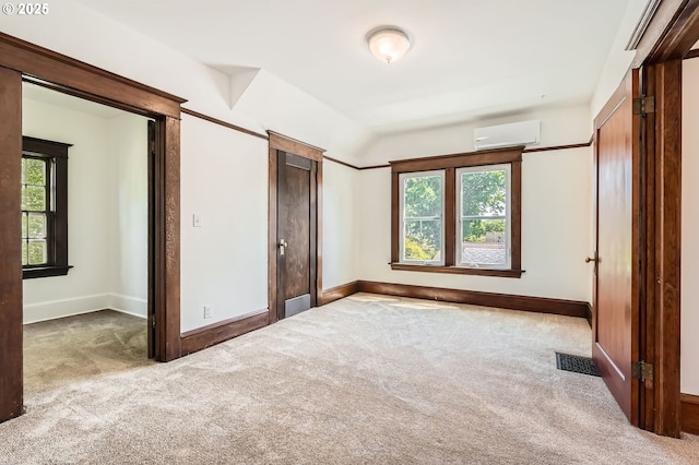 1203 SE 53rd Ave, Portland, OR 97215 - unfurnished bedroom with multiple windows, carpet floors, and a wall mounted air conditioner