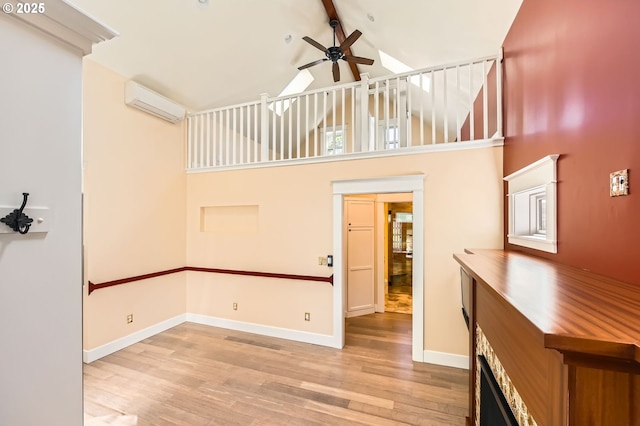 1203 SE 53rd Ave, Portland, OR 97215 - unfurnished living room featuring a wall unit AC, wood finished floors, a ceiling fan, high vaulted ceiling, and beamed ceiling