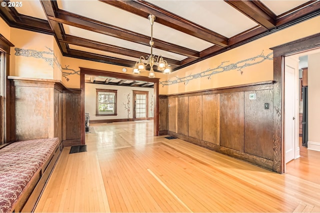 1203 SE 53rd Ave, Portland, OR 97215 - unfurnished dining area featuring light wood-type flooring, a chandelier, a wainscoted wall, and beam ceiling