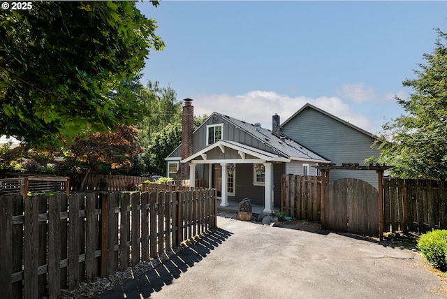 11005 SW 35th Ave, Portland, OR 97219 - rear view of property featuring a chimney and a patio area