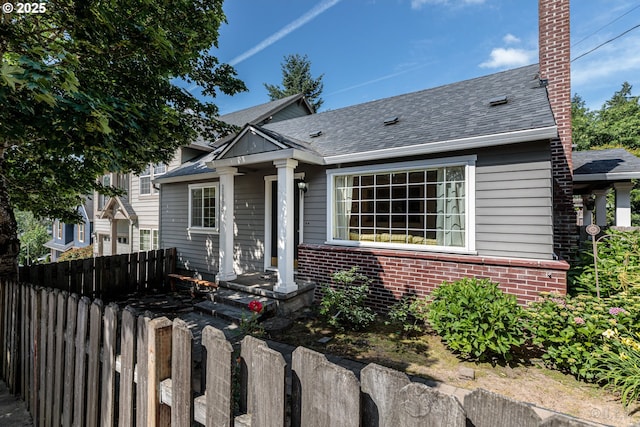11005 SW 35th Ave, Portland, OR 97219 - view of front of property with brick siding, a chimney, and a shingled roof