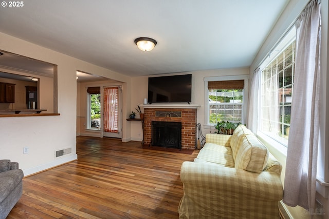 11005 SW 35th Ave, Portland, OR 97219 - living area featuring plenty of natural light, hardwood / wood-style floors, and a brick fireplace