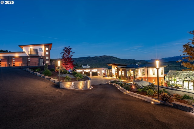 view of front of home with a garage and a mountain view