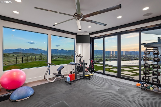 workout room featuring ceiling fan and a mountain view