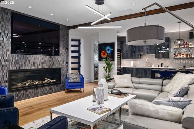 living room featuring hardwood / wood-style floors and wet bar