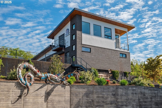 view of side of home with a balcony