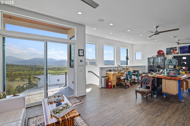 living room with ceiling fan, dark hardwood / wood-style flooring, and a mountain view