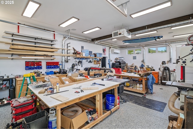 garage featuring a wall mounted air conditioner and a workshop area