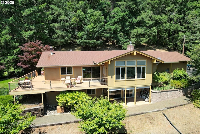 1056 NE Orchard Dr, Myrtle Creek, OR 97457 - back of property with a deck, a chimney, and a shingled roof