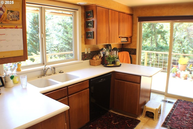 1056 NE Orchard Dr, Myrtle Creek, OR 97457 - kitchen with dishwasher, healthy amount of natural light, brown cabinets, and a peninsula