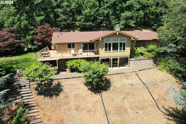 1056 NE Orchard Dr, Myrtle Creek, OR 97457 - back of property featuring a wooden deck, a shingled roof, and stairway