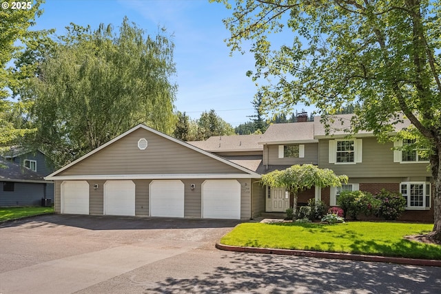562 SW Eastman Pkwy, Gresham, OR 97080 - view of front facade featuring asphalt driveway, a front lawn, a chimney, and a garage