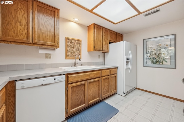 562 SW Eastman Pkwy, Gresham, OR 97080 - kitchen with white appliances, a sink, brown cabinets, and light flooring