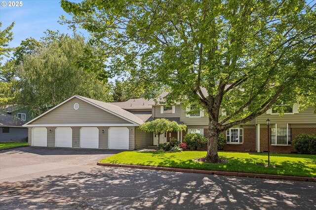 562 SW Eastman Pkwy, Gresham, OR 97080 - view of front of house with a front yard, brick siding, and asphalt driveway
