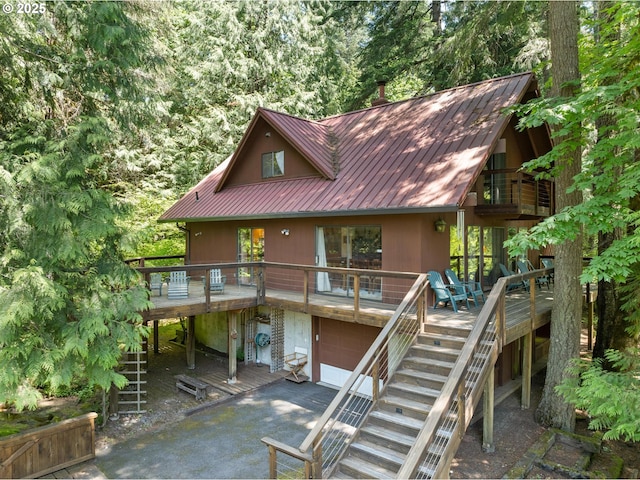 70198 E Barlow Trail Rd, Rhododendron, OR 97049 - view of front of home featuring stairs, a wooden deck, asphalt driveway, and a garage