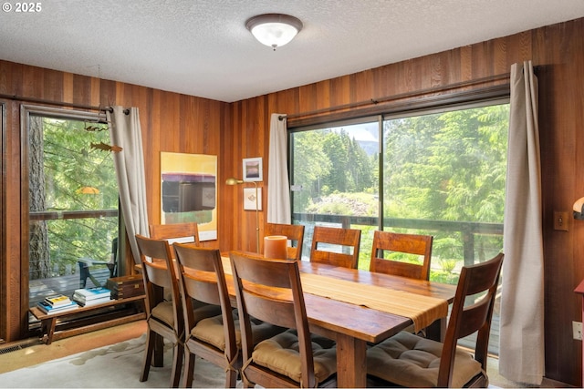 70198 E Barlow Trail Rd, Rhododendron, OR 97049 - dining room featuring wooden walls and a textured ceiling