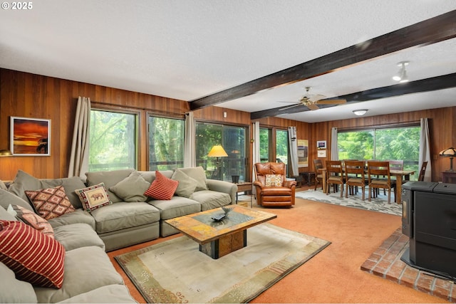 70198 E Barlow Trail Rd, Rhododendron, OR 97049 - living area featuring wooden walls, a wood stove, light carpet, beamed ceiling, and a textured ceiling