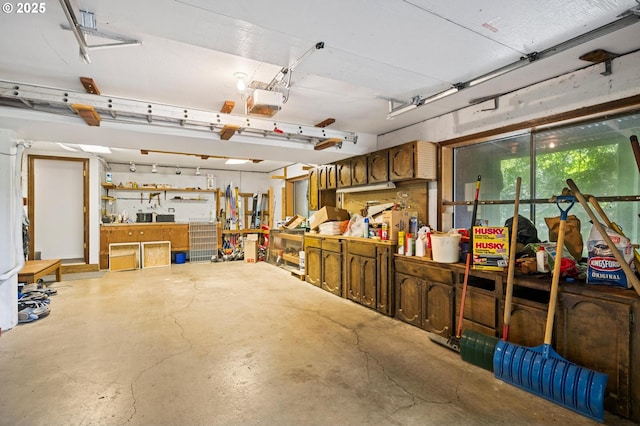 70198 E Barlow Trail Rd, Rhododendron, OR 97049 - garage featuring a garage door opener and a workshop area