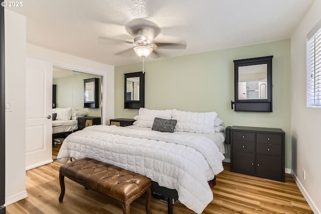 bedroom featuring a closet, a ceiling fan, baseboards, and wood finished floors