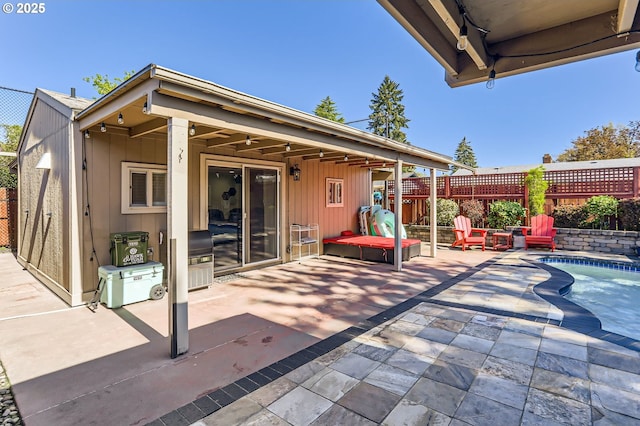 view of patio with fence and a fenced in pool