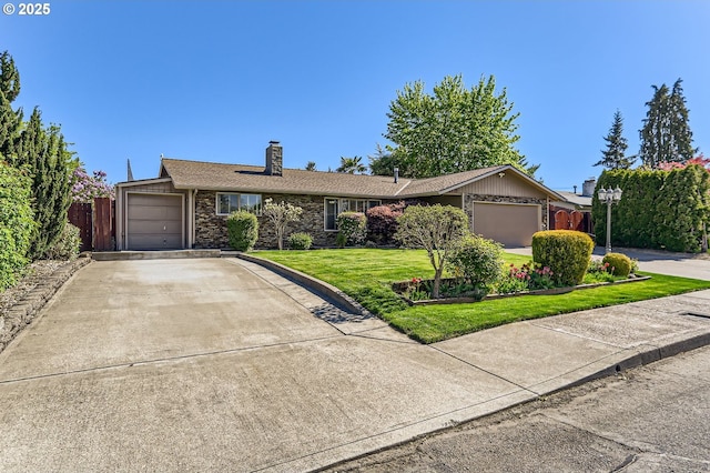 ranch-style home featuring a chimney, a garage, a front lawn, concrete driveway, and stone siding