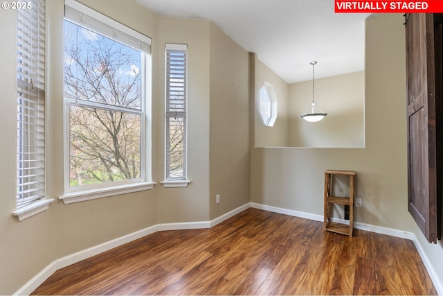 interior space with baseboards and wood finished floors