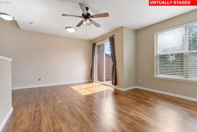 empty room with baseboards, a ceiling fan, and wood finished floors