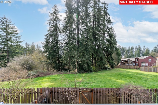 view of yard with a fenced backyard