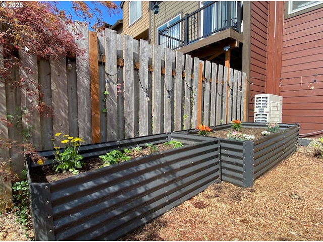 exterior details featuring fence and a vegetable garden