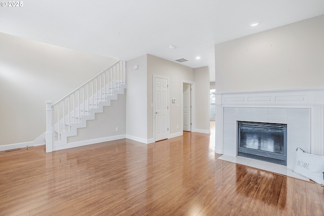 unfurnished living room with a fireplace and light hardwood / wood-style flooring