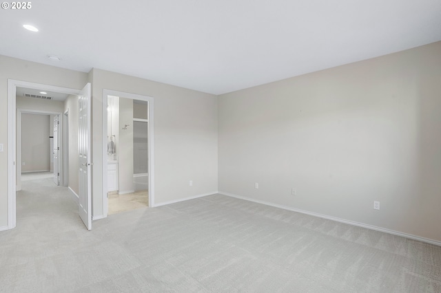 spare room with light colored carpet