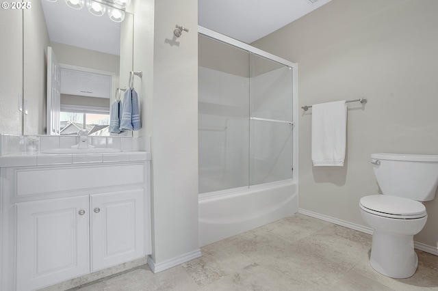 full bathroom featuring enclosed tub / shower combo, vanity, and toilet