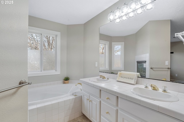 bathroom featuring vanity and a relaxing tiled tub