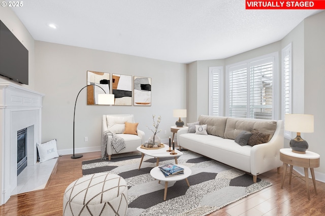 living room featuring light hardwood / wood-style floors and a textured ceiling