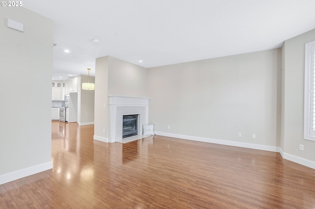 unfurnished living room with light wood-type flooring