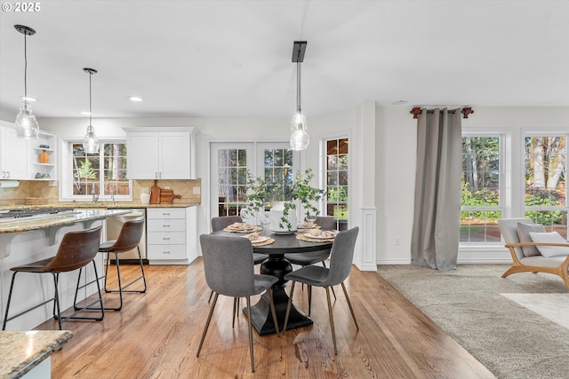 dining room featuring recessed lighting, baseboards, and light wood finished floors