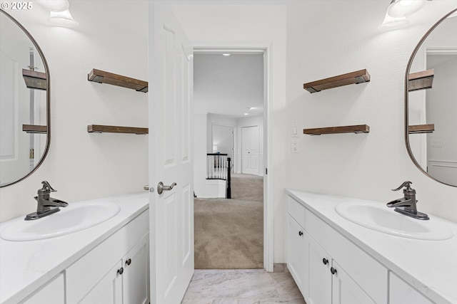 bathroom featuring two vanities and a sink