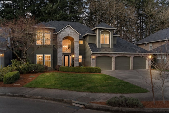 view of front facade with driveway, roof with shingles, a front yard, a garage, and brick siding