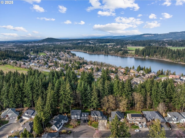 birds eye view of property featuring a residential view, a forest view, and a water and mountain view