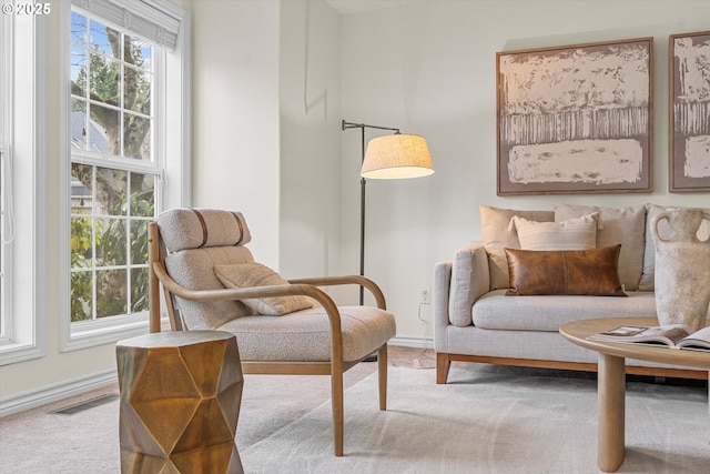 interior space featuring visible vents, baseboards, and carpet floors