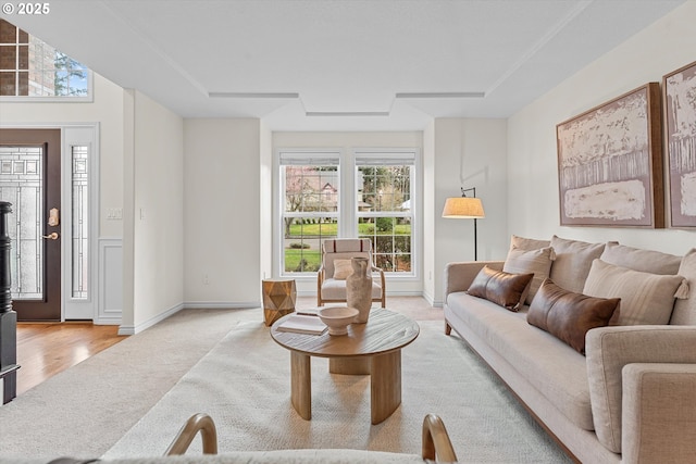 carpeted living room featuring a wood stove and baseboards