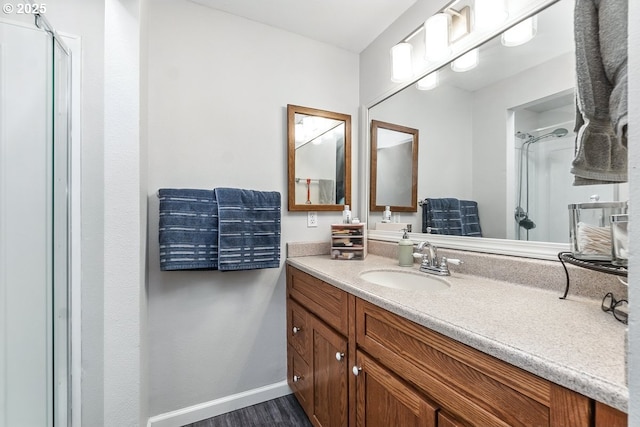 14938 SW 109th Ave, Portland, OR 97224 - full bath featuring a stall shower, vanity, baseboards, and wood finished floors