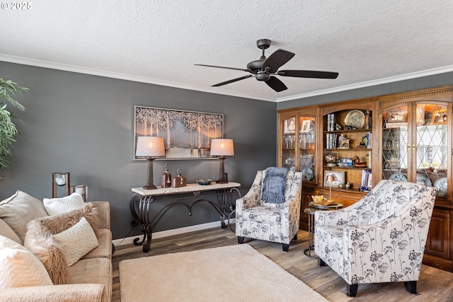 440 S Cascade Dr, Woodburn, OR 97071 - living room with a ceiling fan, crown molding, wood finished floors, a textured ceiling, and baseboards