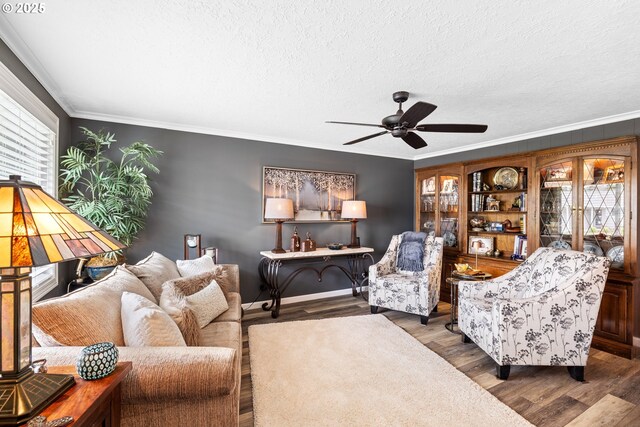 440 S Cascade Dr, Woodburn, OR 97071 - living room featuring a ceiling fan, ornamental molding, wood finished floors, and a textured ceiling